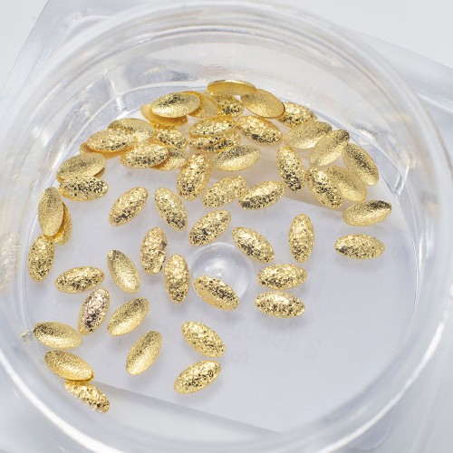 Komilfo texture rivets large oval 1.5*3 mm, gold, 50 pcs Komilfo texture rivets large oval 1.5*3 mm, gold, 50 pcs